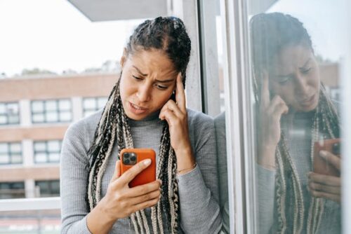 stressed woman looking at phone