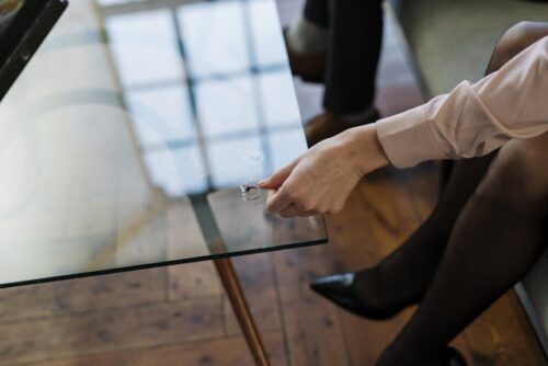 woman taking ring off and putting it on table